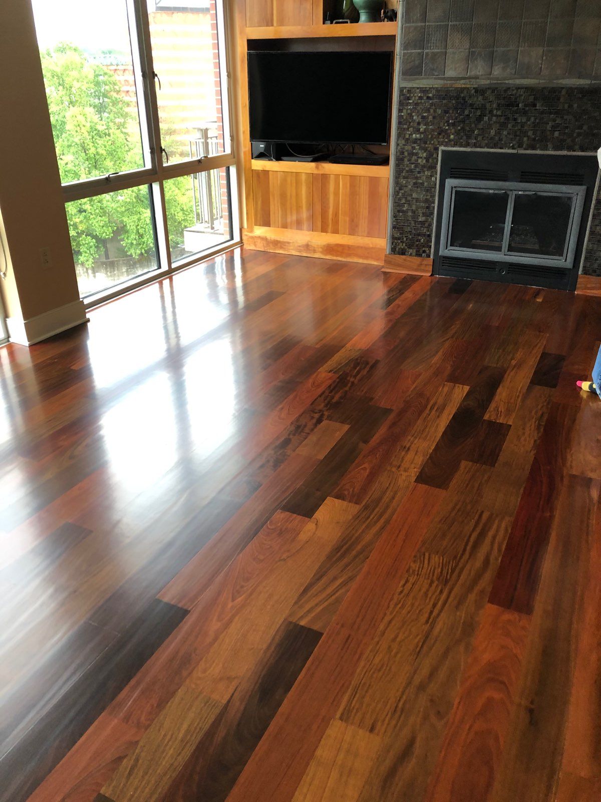 A living room with hardwood floors and a fireplace.