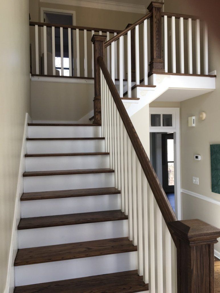 A staircase with a white railing and wooden steps
