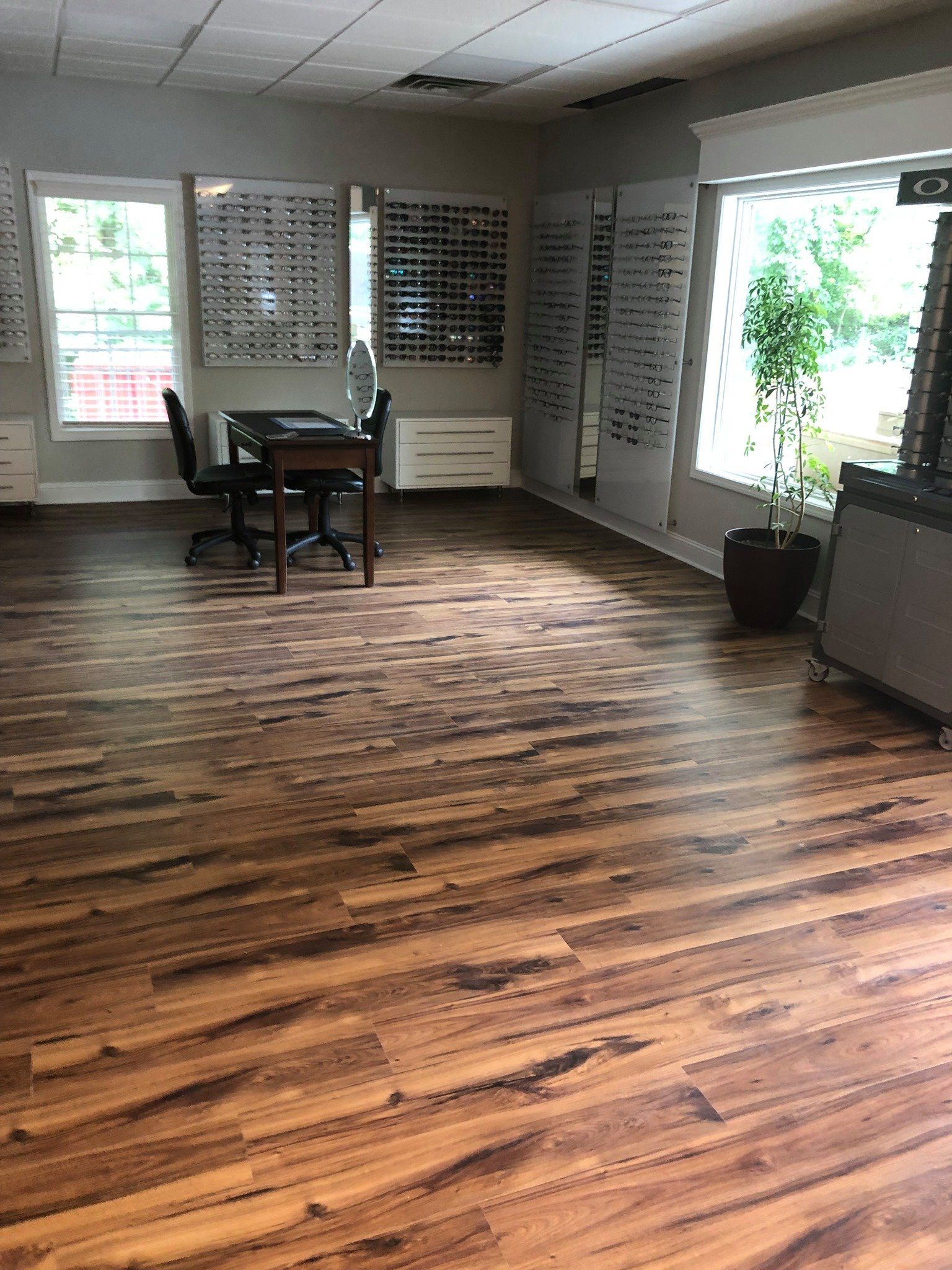 A large room with a wooden floor and a table and chairs in it.