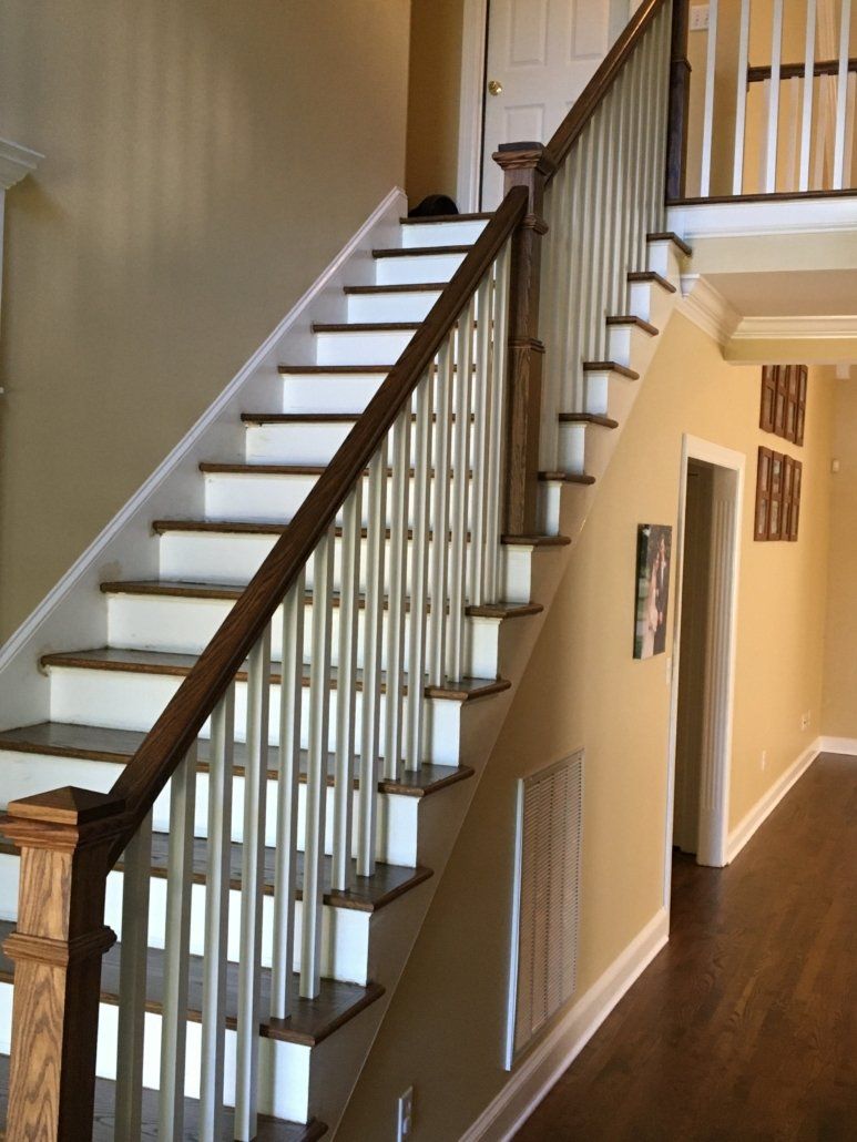 A staircase with white steps and a wooden railing