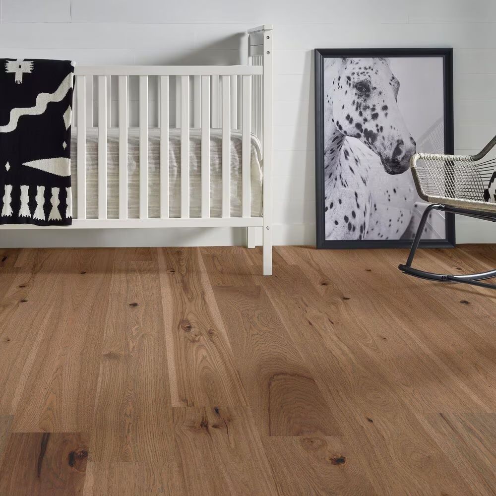 A room with a crib and a picture of a dalmatian