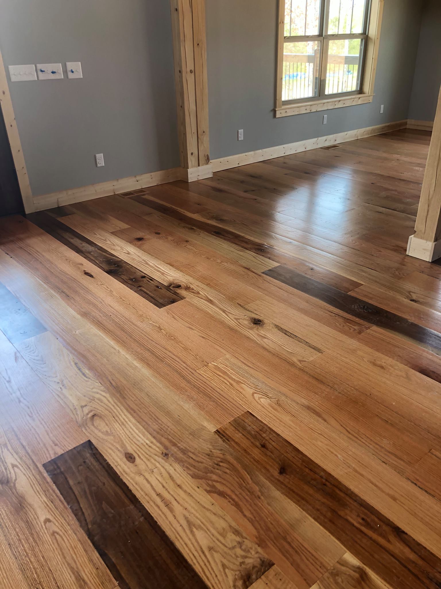 A living room with hardwood floors and a window.