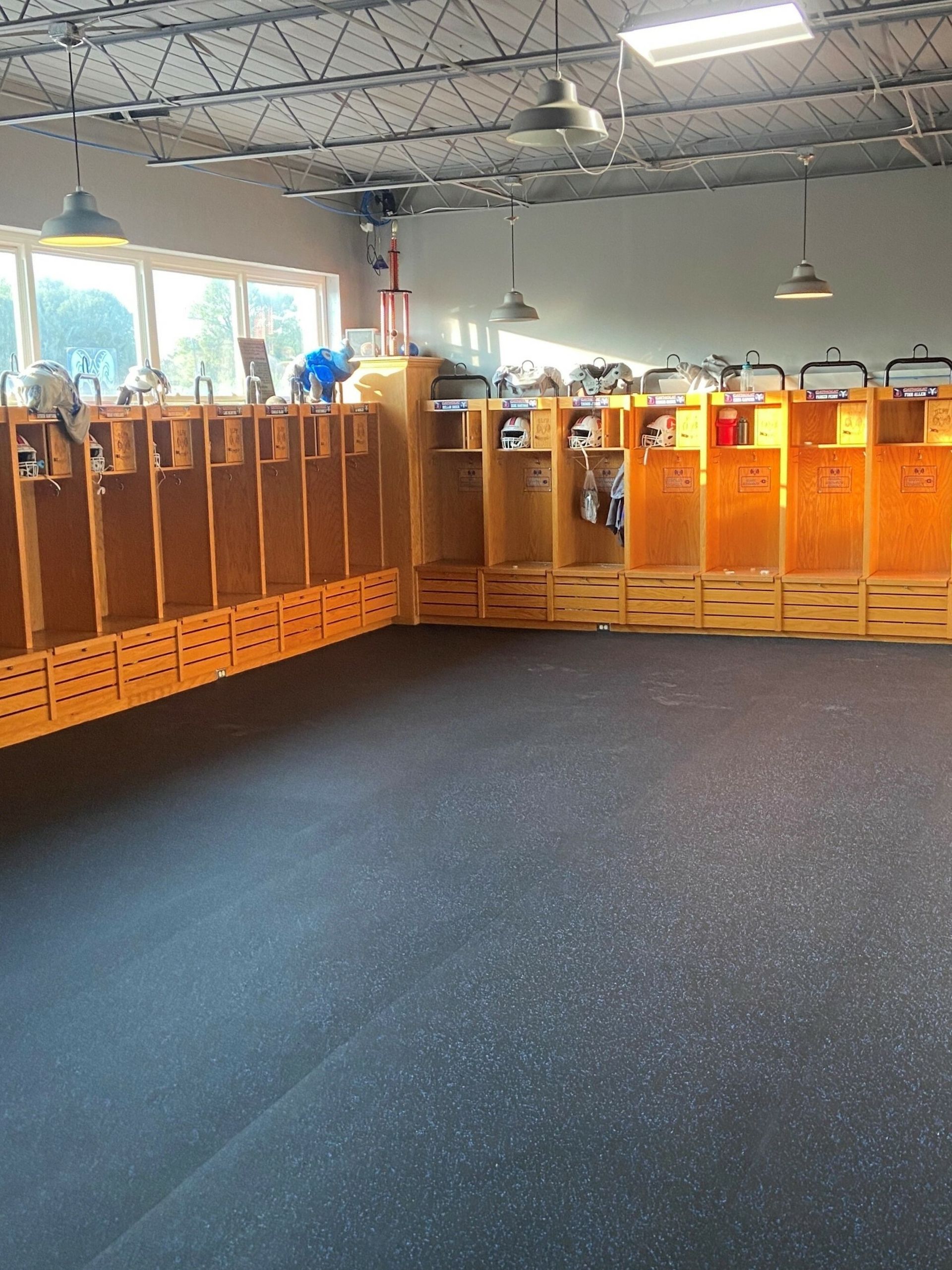 A locker room with a lot of wooden lockers