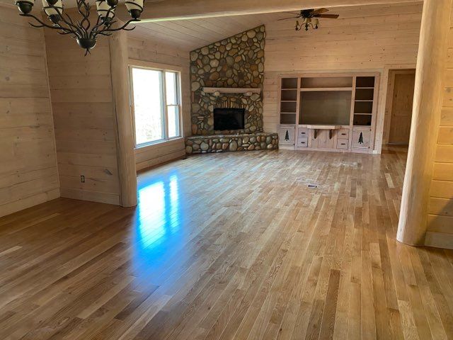 A living room with hardwood floors and a fireplace
