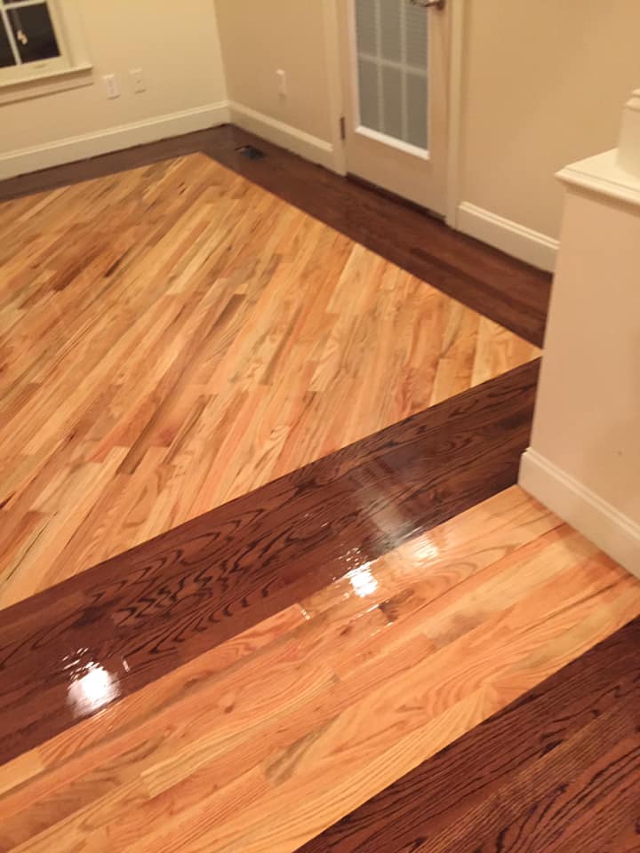 A room with a wooden floor and a door.