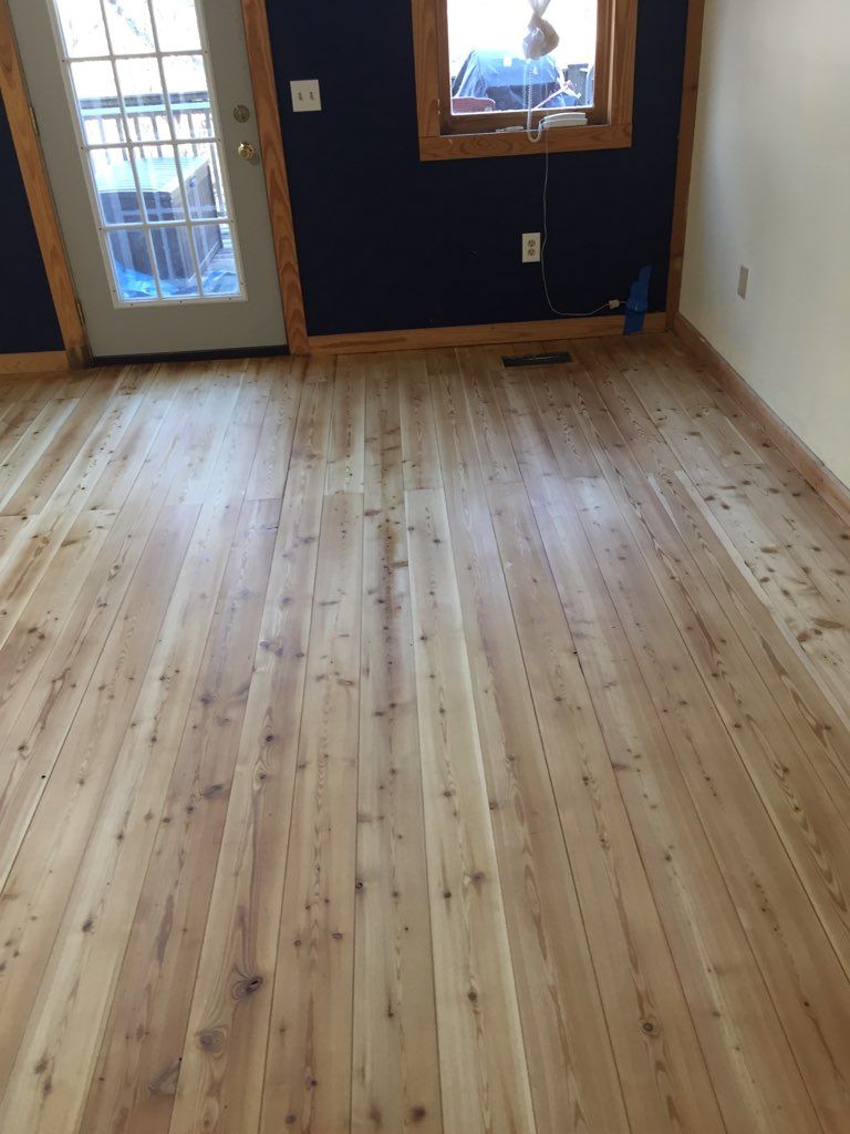 A room with a wooden floor and a window.