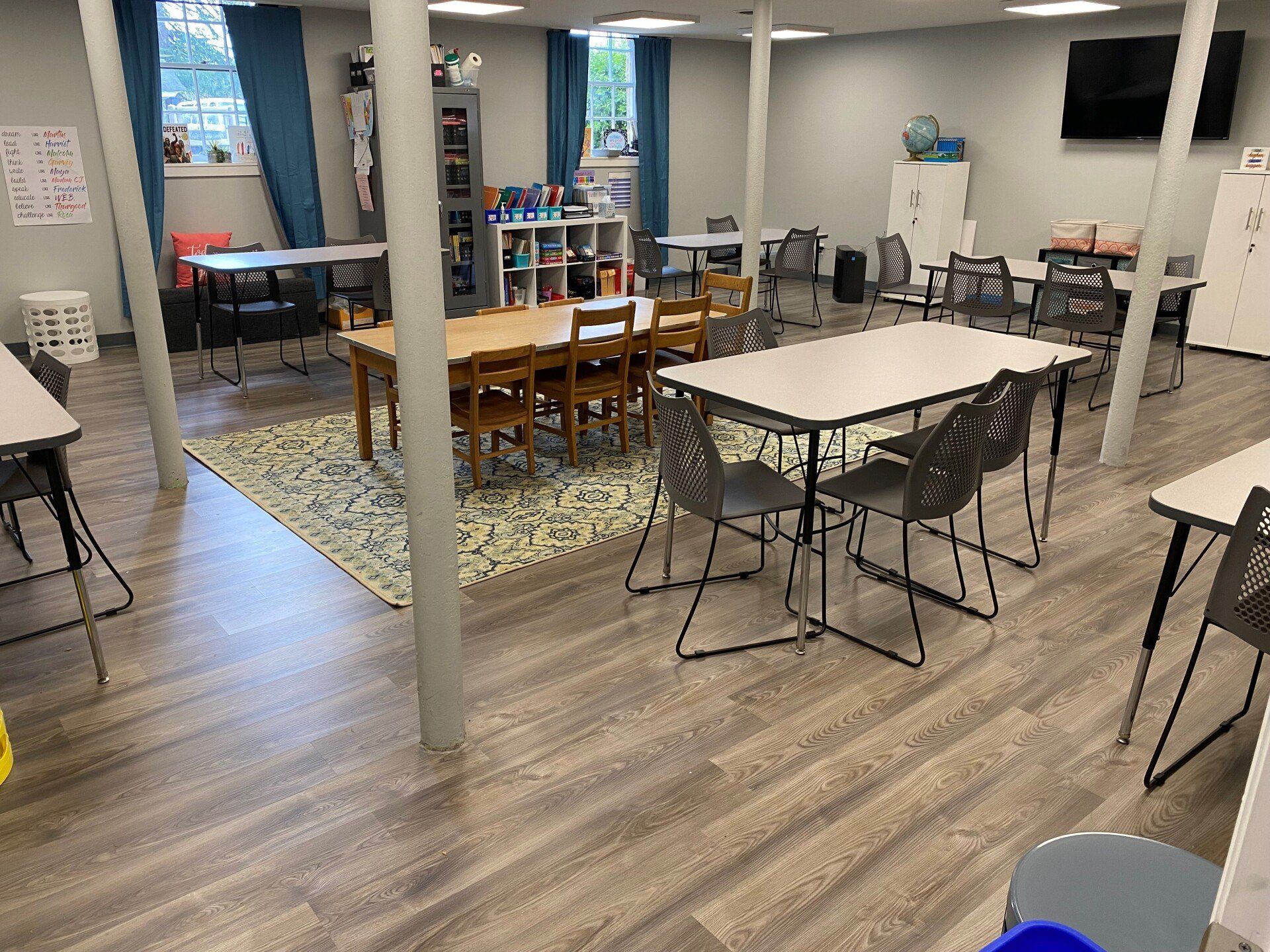 A large room with tables and chairs in it.