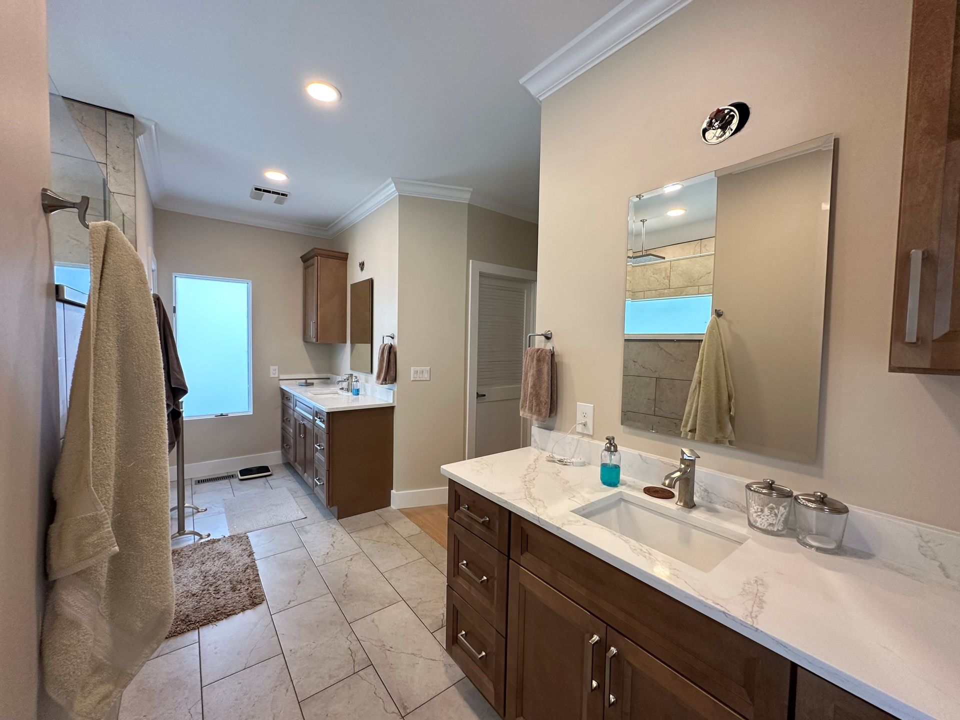 A bathroom with two sinks and a large mirror.