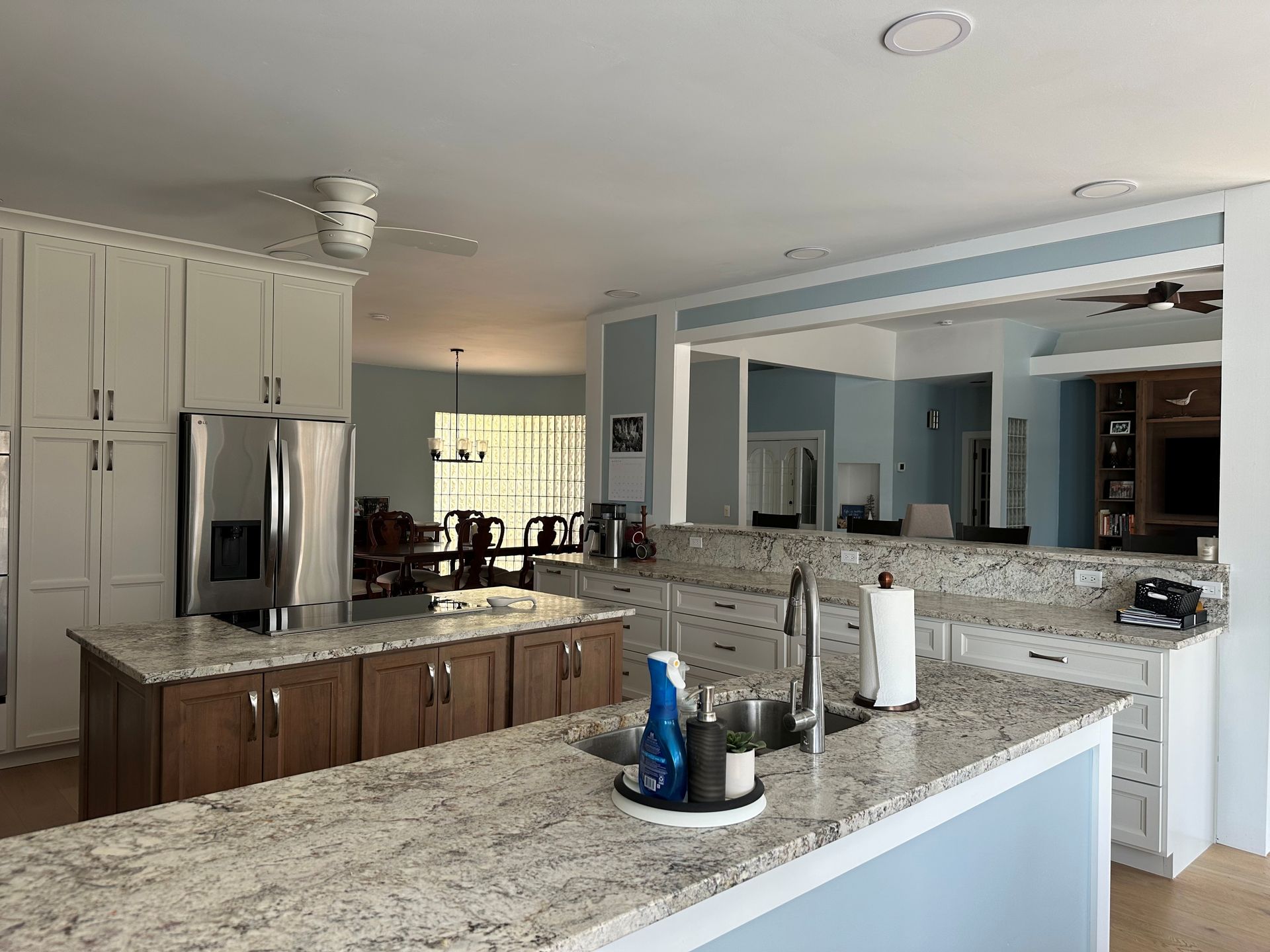 A kitchen with granite counter tops and stainless steel appliances.