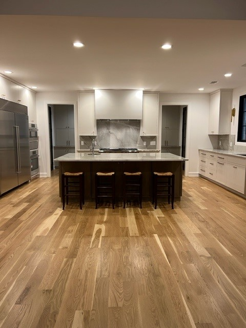 A kitchen with a large island and stools