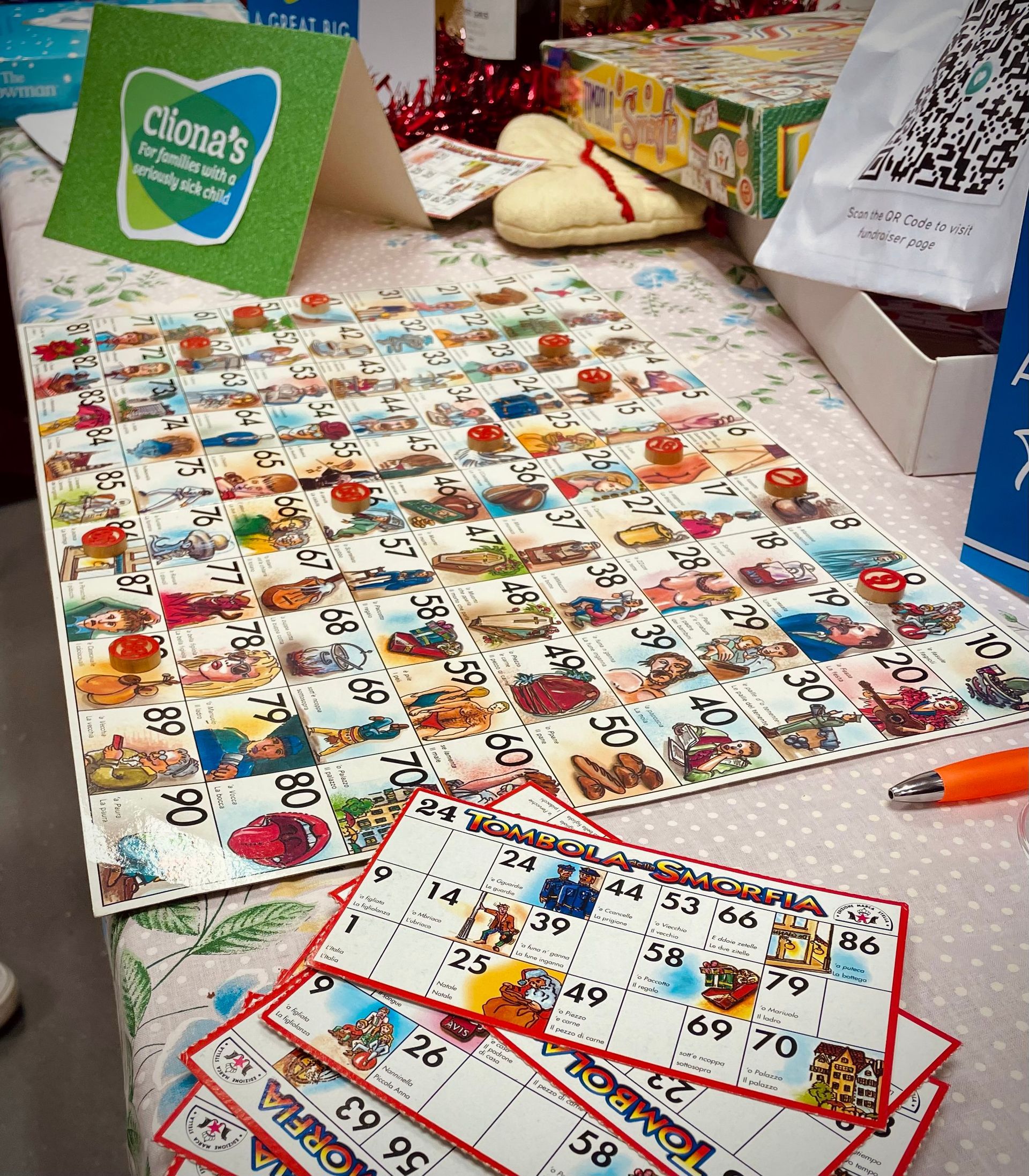 A bingo game set up on a table with a Cliona's Foundation sign.