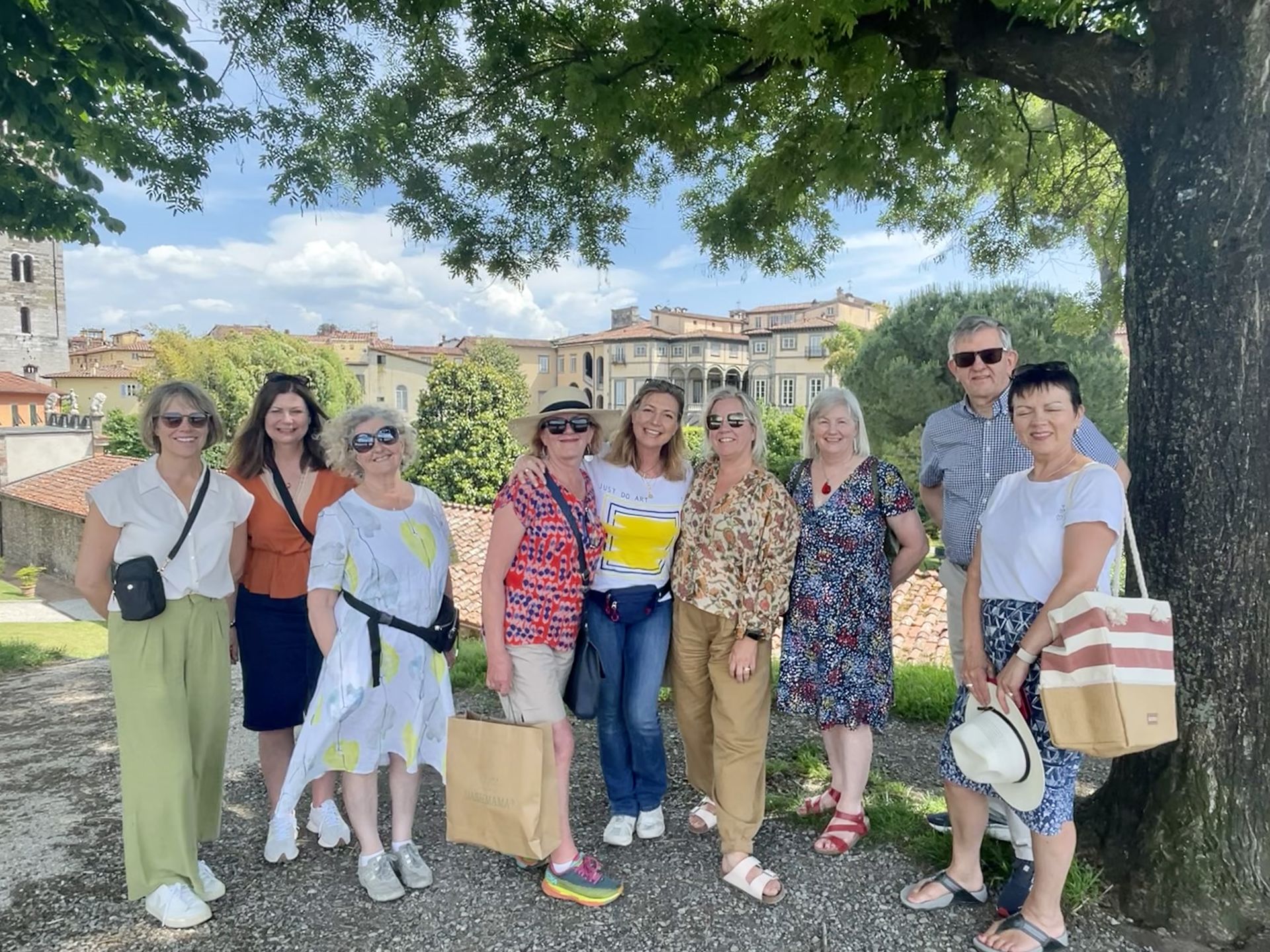A group of people are posing for a picture under a tree.