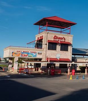 A car wash with a red roof and a sign that says soft fresh tunnel