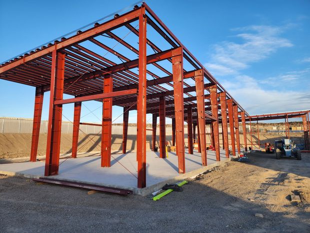 A person is sitting at a desk in front of a computer monitor.