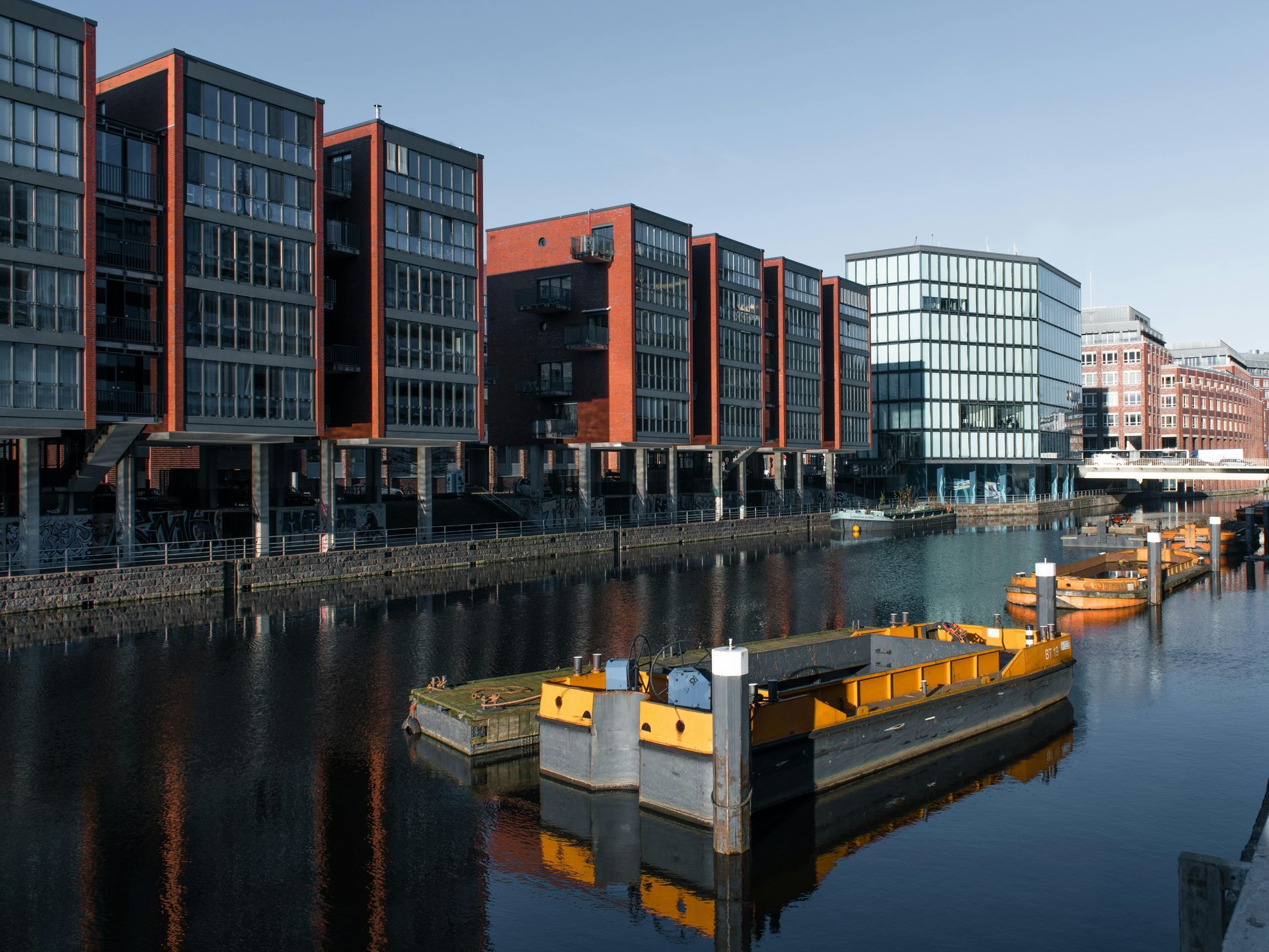 A row of buildings are next to a body of water.