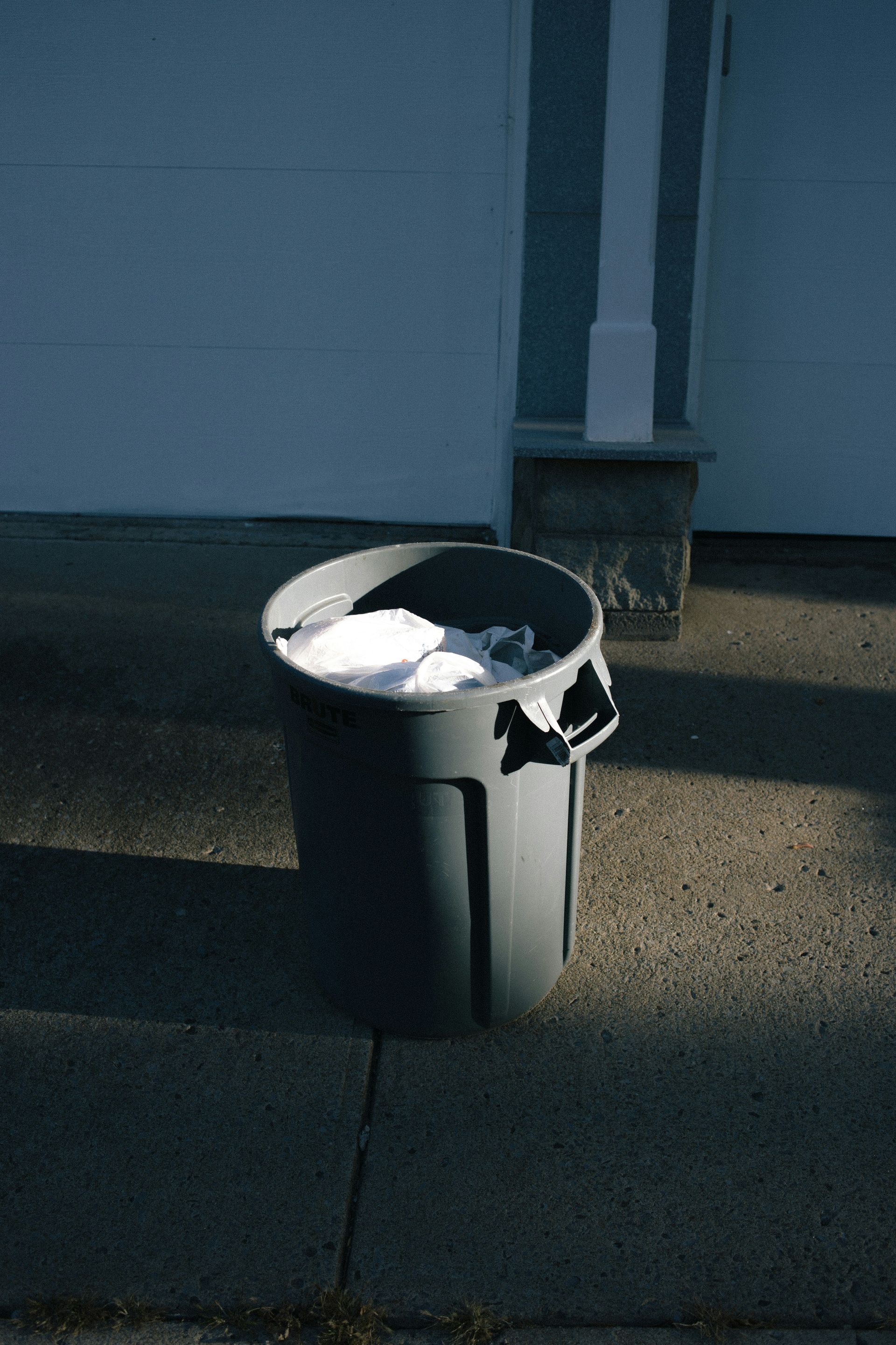 A moody depiction of one single full trash can