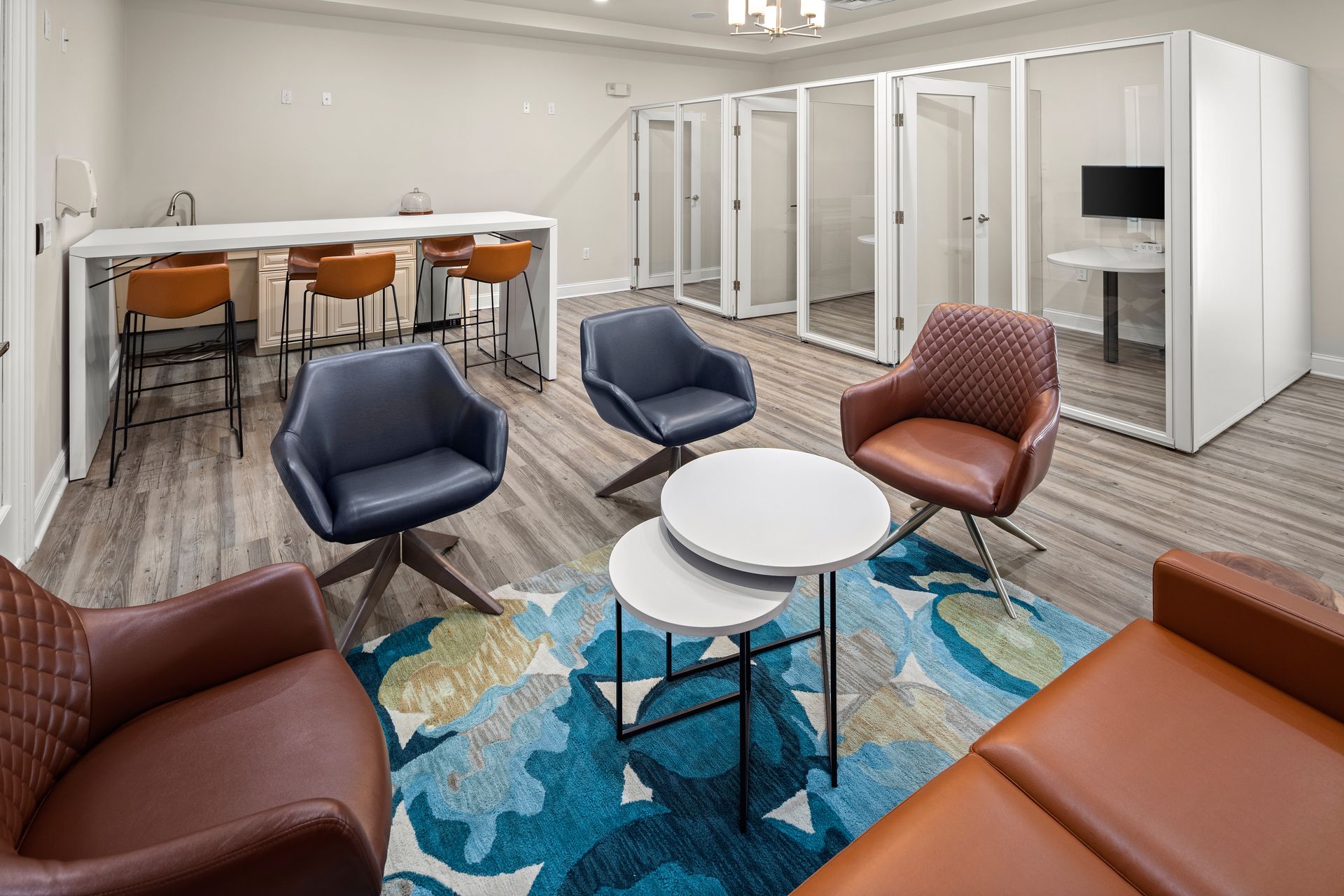 A living room with a couch , chairs , tables and a table.