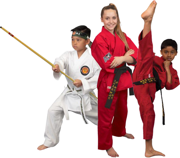 A woman in a red karate uniform is standing next to two children