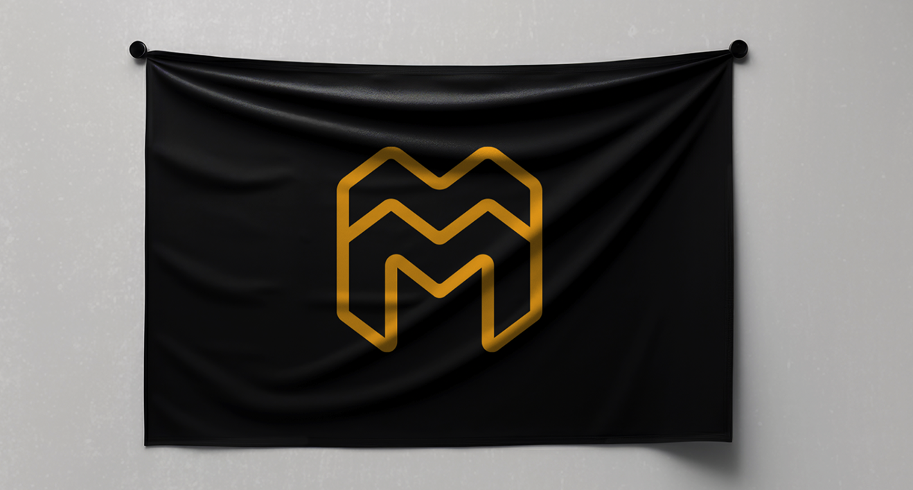 Black flag with gold outlined double M design hanging on a white wall.
