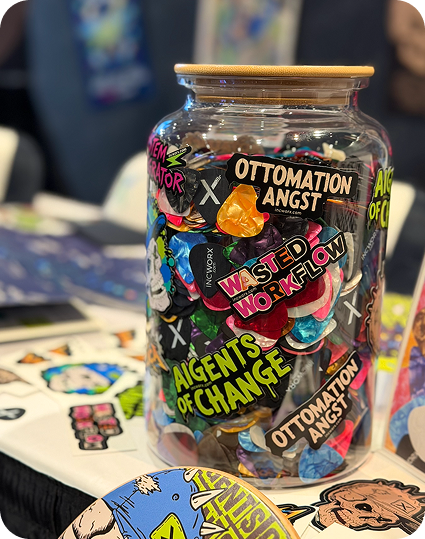 A jar filled with stickers on a table, including 