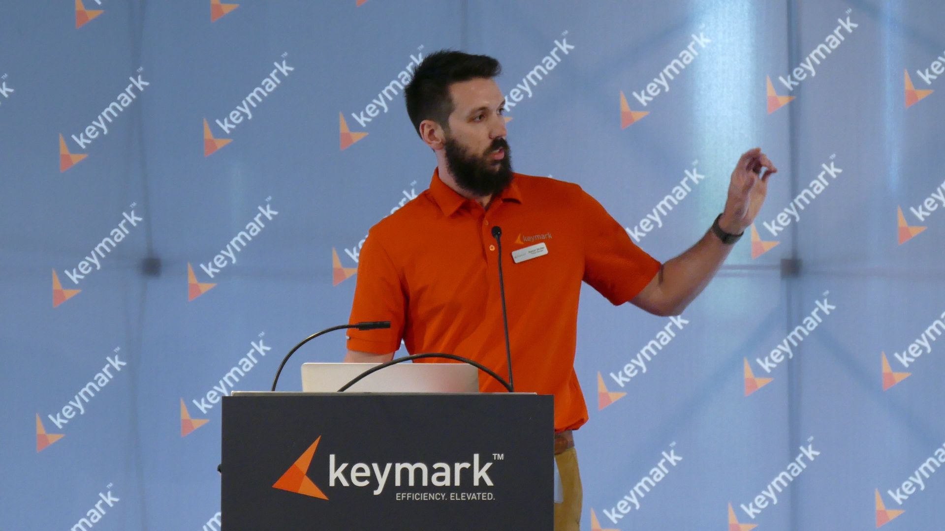 Flag with vertical stripes: black, teal, white, purple, and light blue.