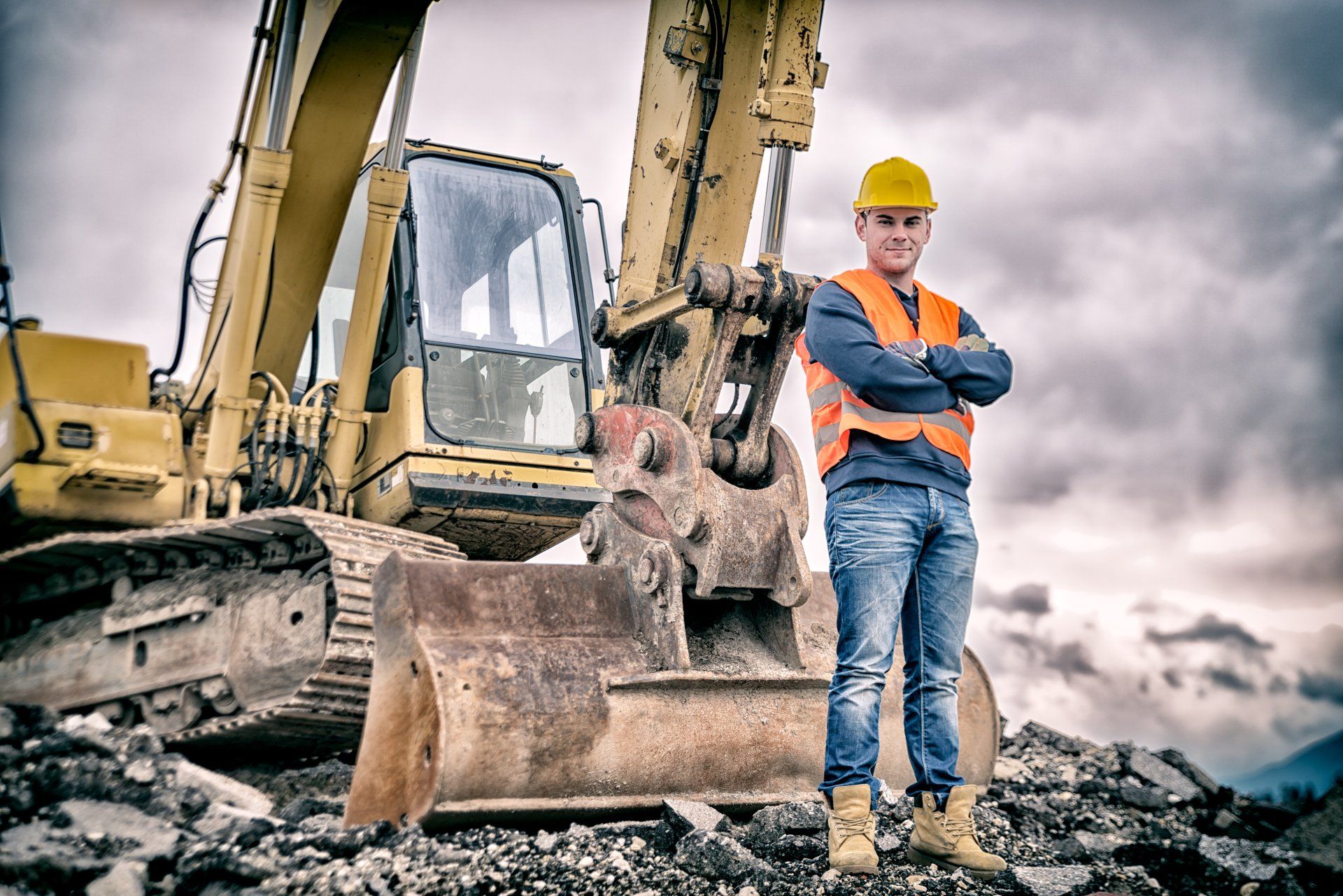 An Excavator And A Construction Worker — Elysburg, PA — Stadium Dirt Designs Inc.
