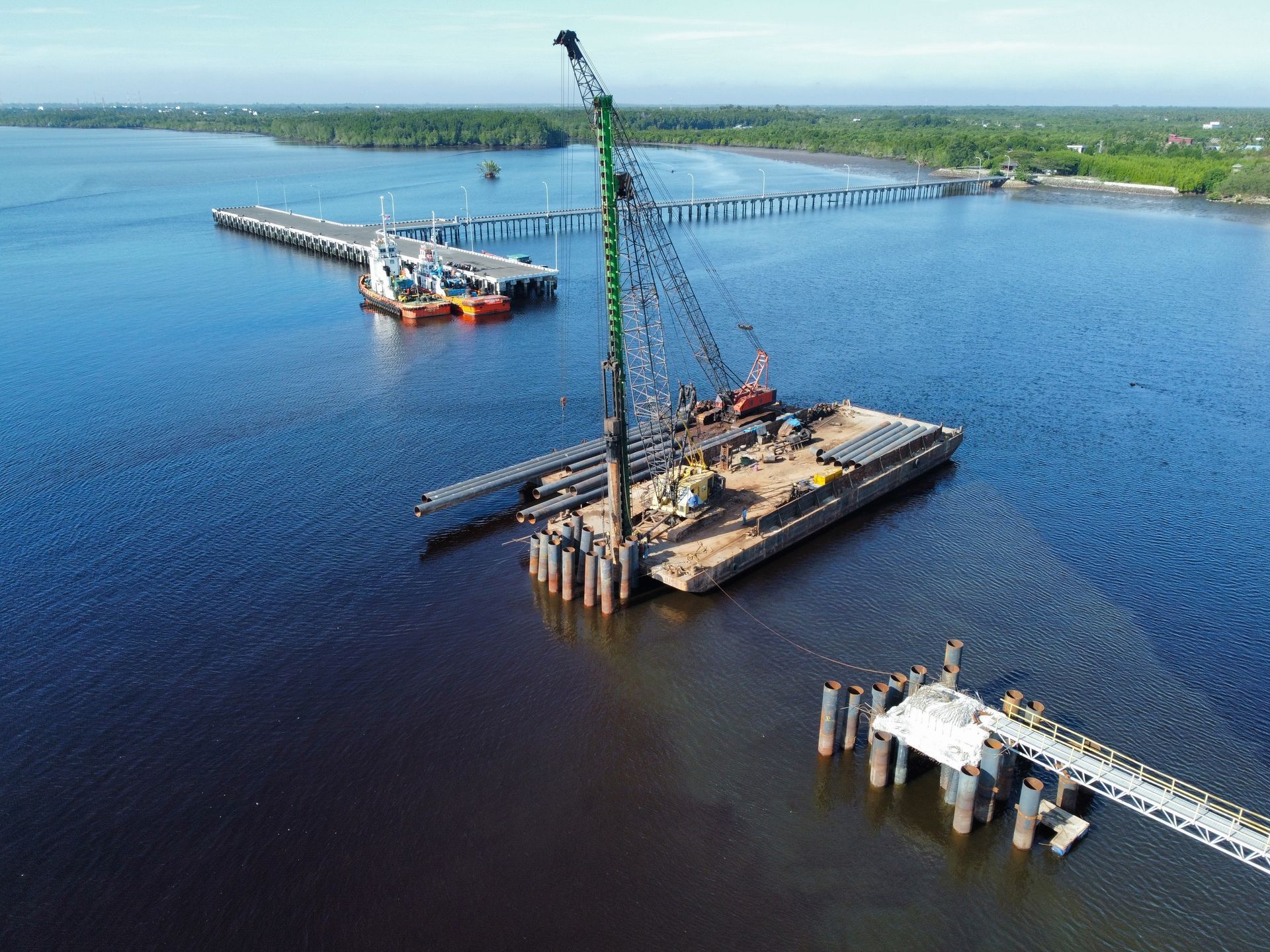 An aerial view of a bridge being built in the water.