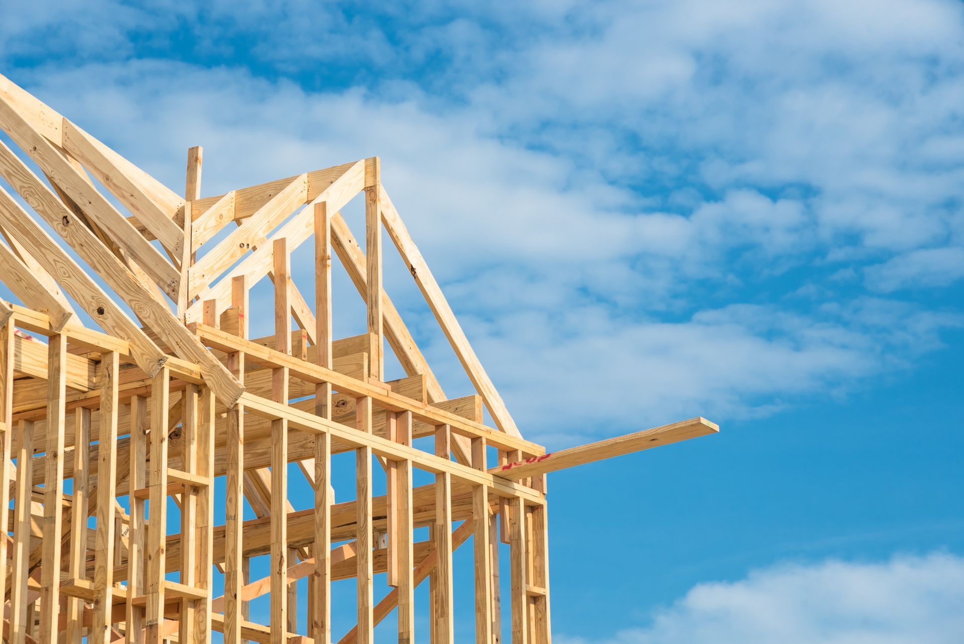 A house is being built with a blue sky in the background.