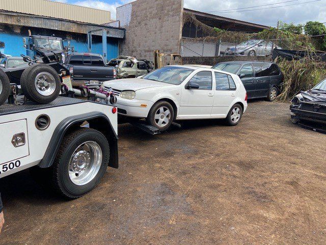 Towed White Car - Maui Auto Recycling in Puunene, HI