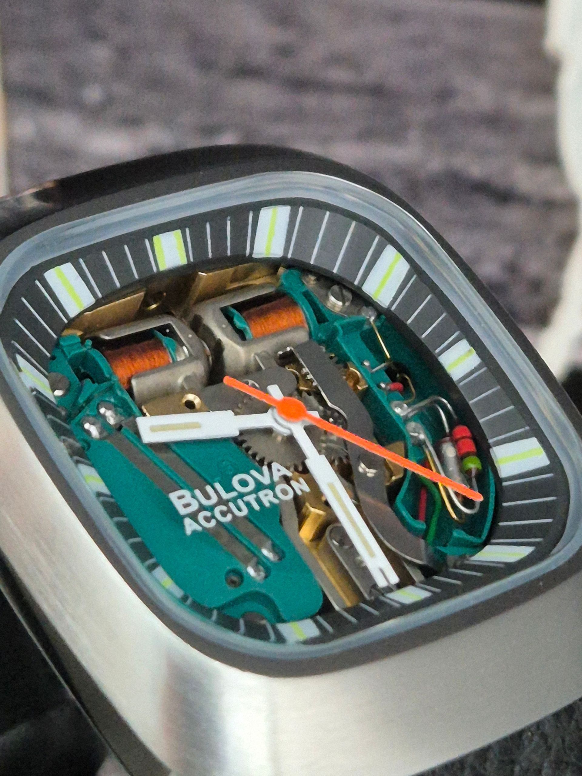 Bulova Accutron watch with open face, showcasing internal gears and components.
