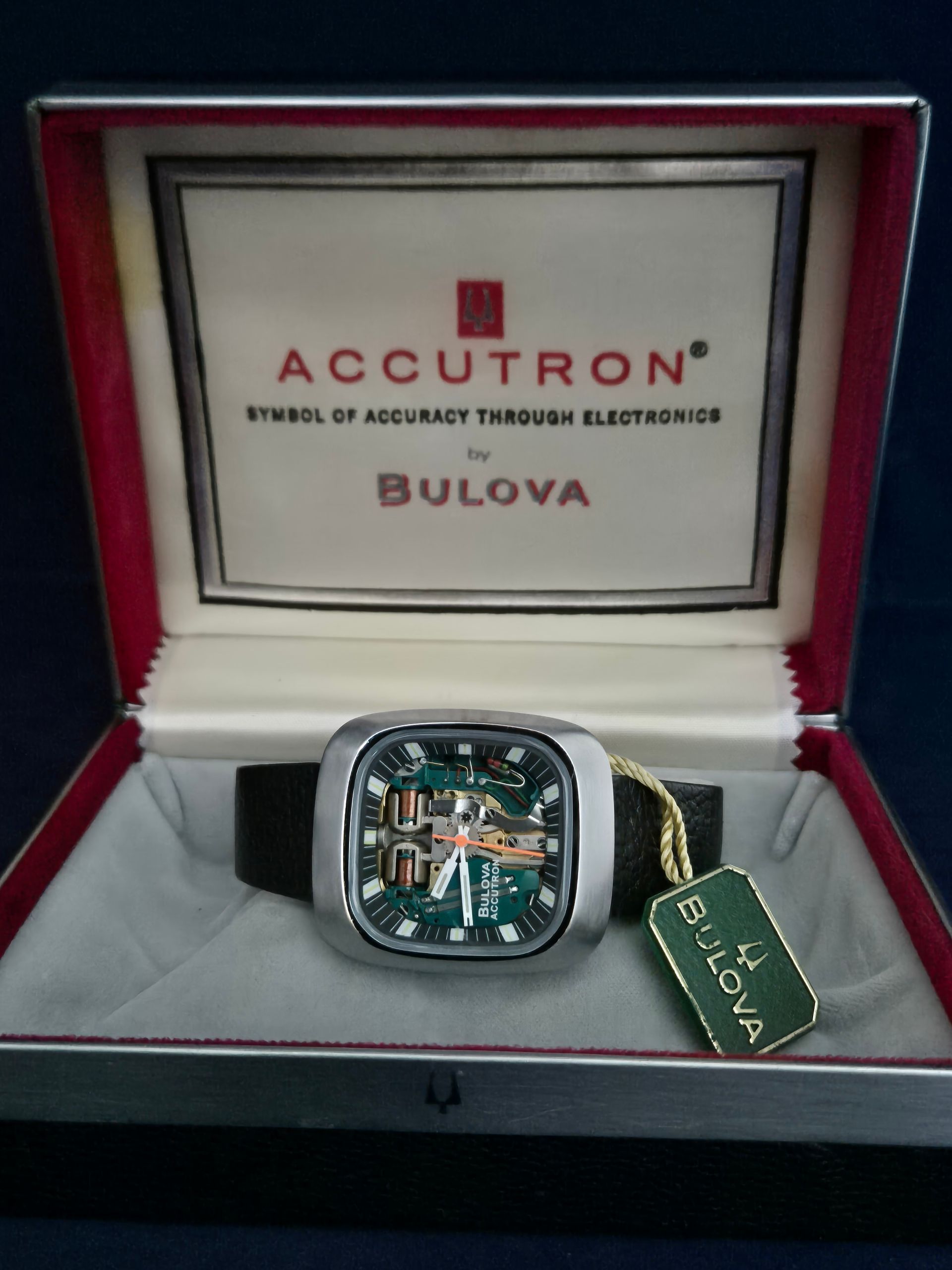 Bulova Accutron watch in its original box with a green and white tag.