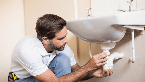 Professional doing the plumbing work in the house