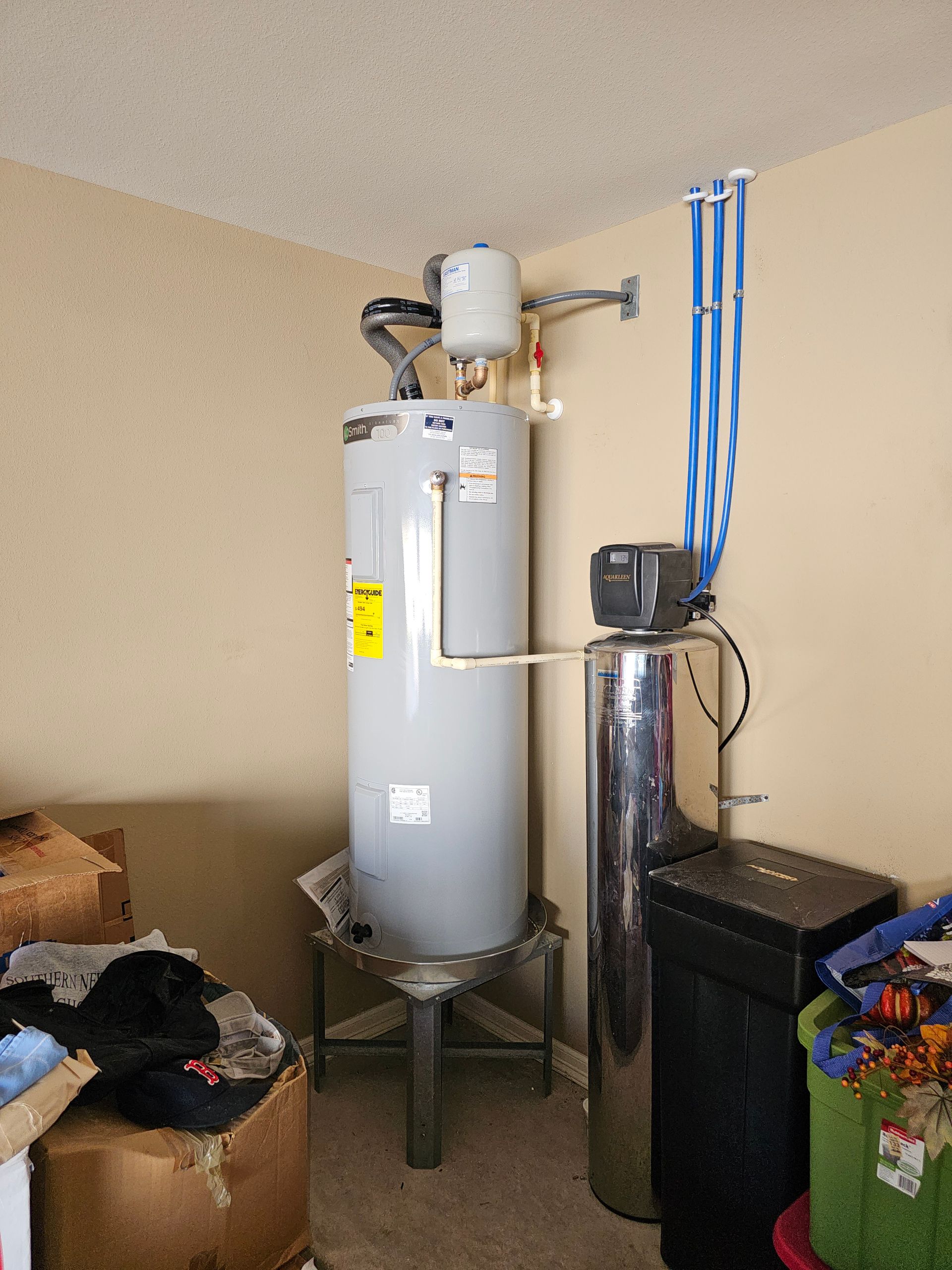 a room with a water heater and a water softener