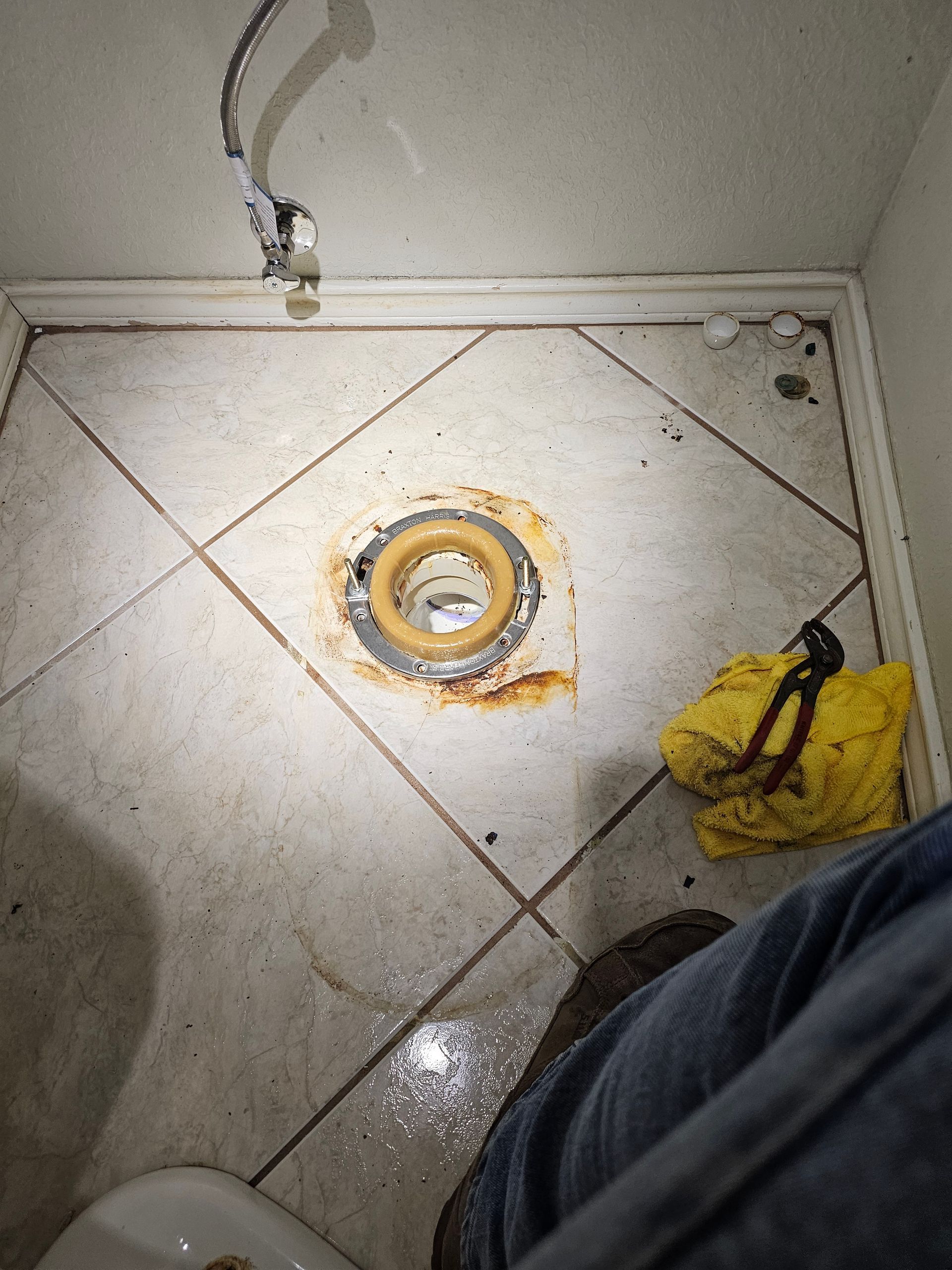 a person is standing in a bathroom next to a toilet