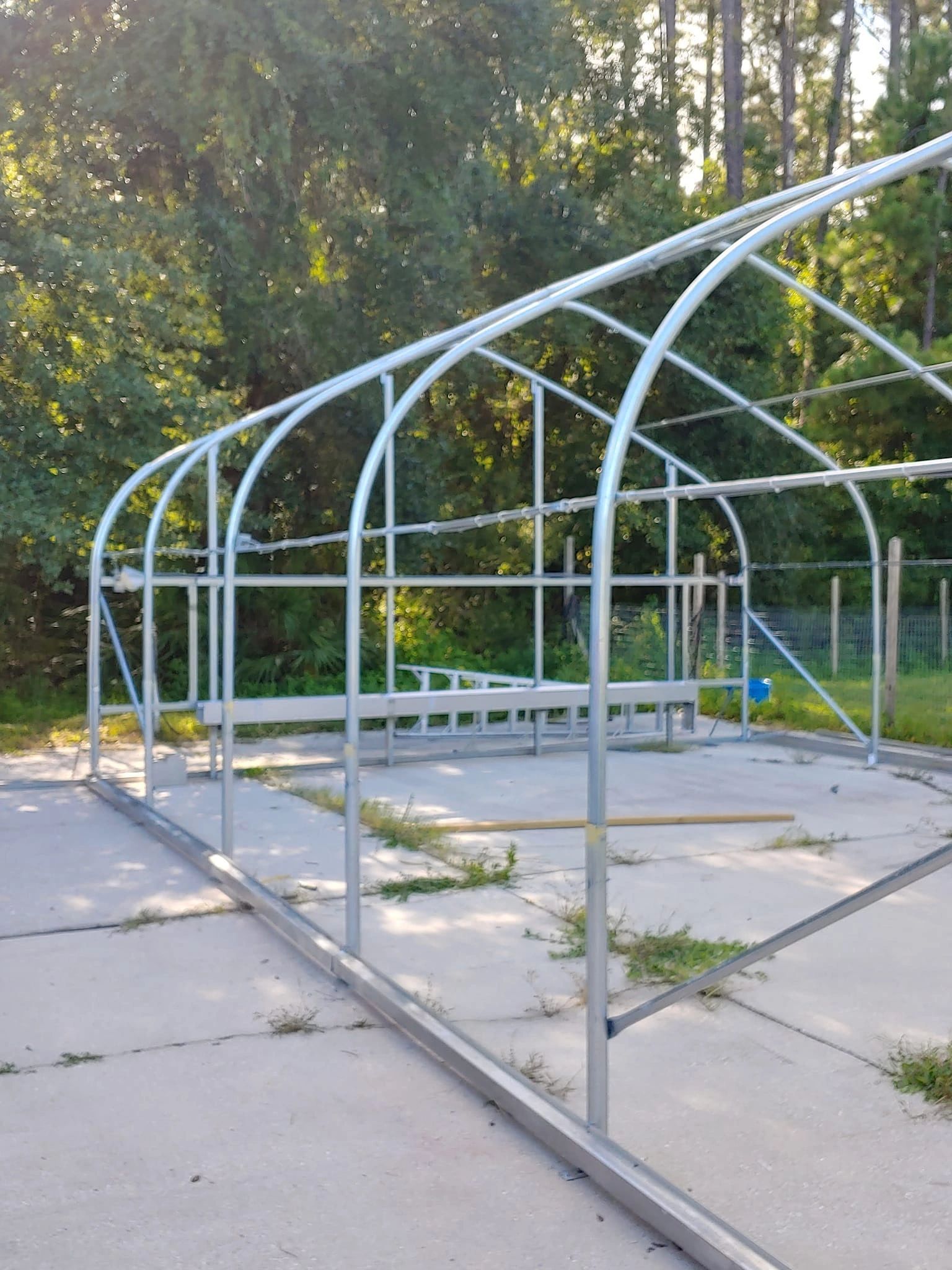 A greenhouse is being built on the side of a road.