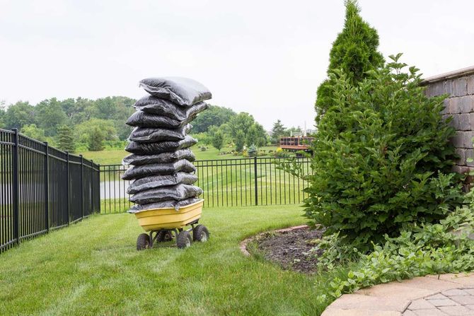 Mulch bags piled high on a cart — Omaha, NE  — Tim’s Tree Service and Mulch