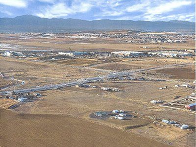 An aerial view of a desert landscape with mountains in the background