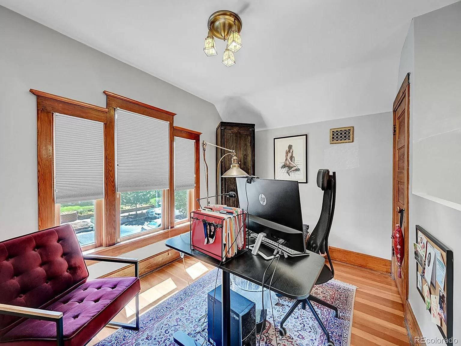 A home office with a desk , chair and computer.