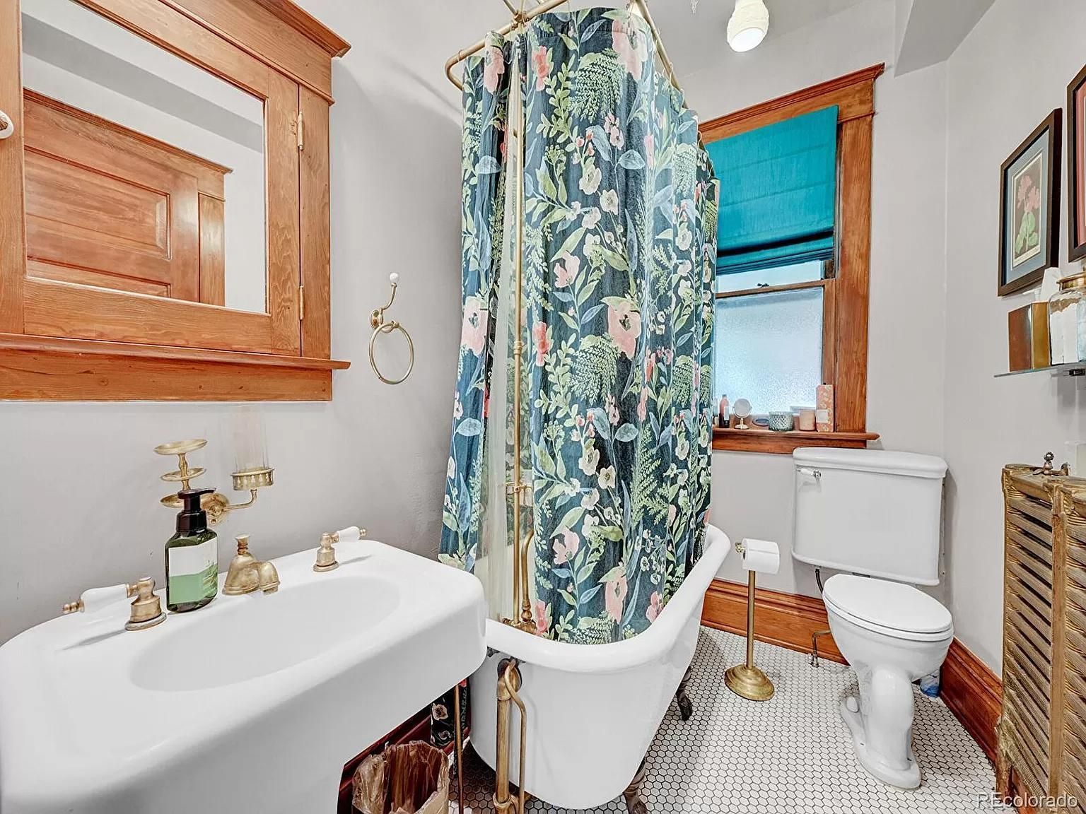 A bathroom with a bathtub , toilet , sink and mirror.
