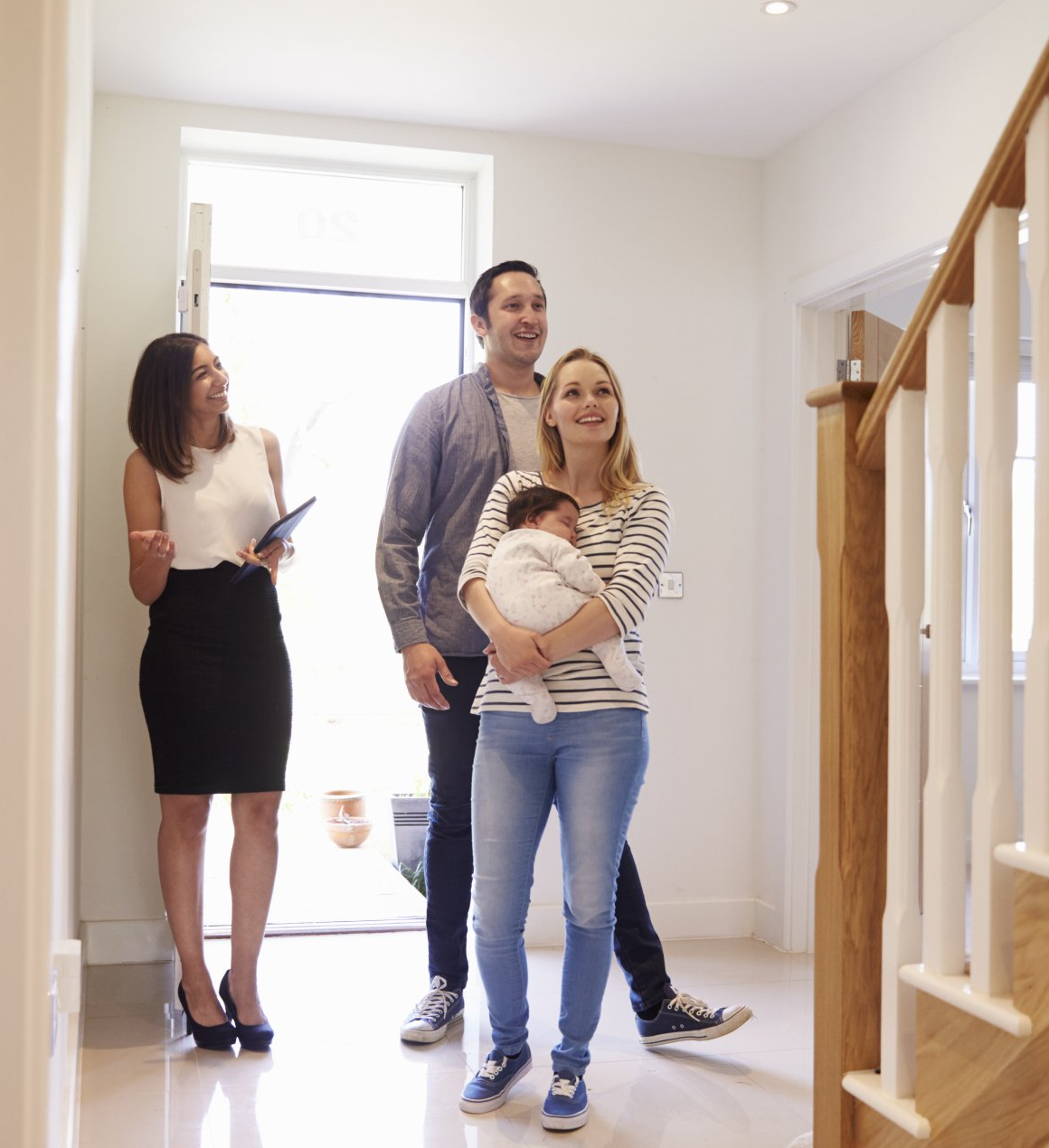 Realtor Showing Young Couple Around Property For Sale