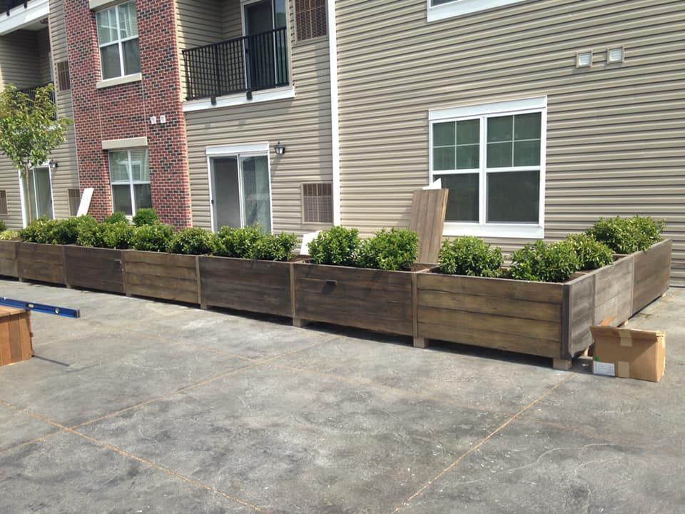 A row of wooden planters in front of a building