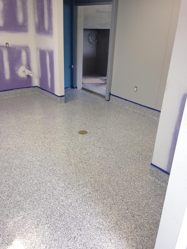 A room with a white floor and purple walls.