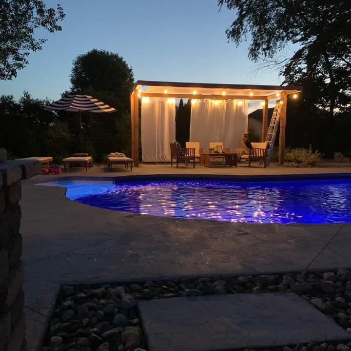 A large swimming pool is lit up at night