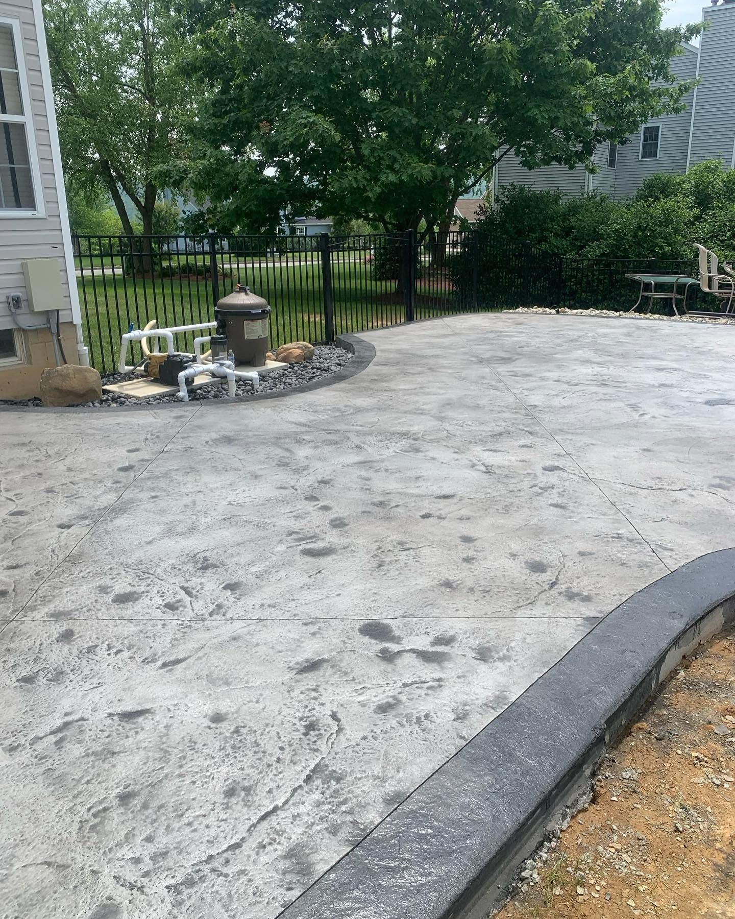 A concrete driveway is being built in front of a house.