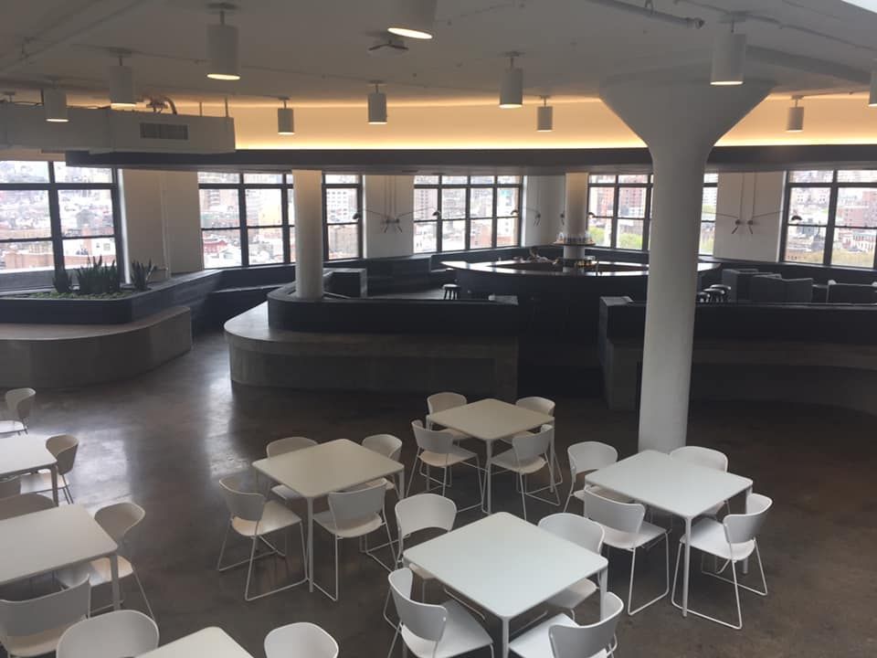 A large room with tables and chairs in it