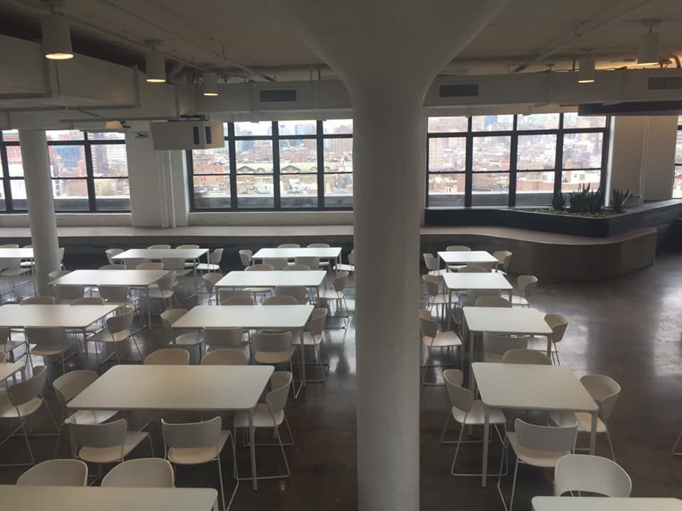 A large room with lots of tables and chairs