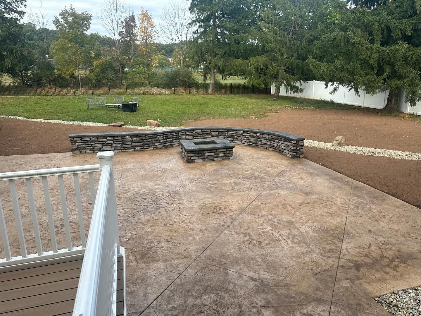 There is a fire pit in the middle of the patio.