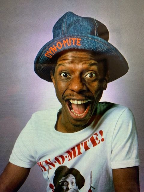 A man wearing a hat with dynamite written on it