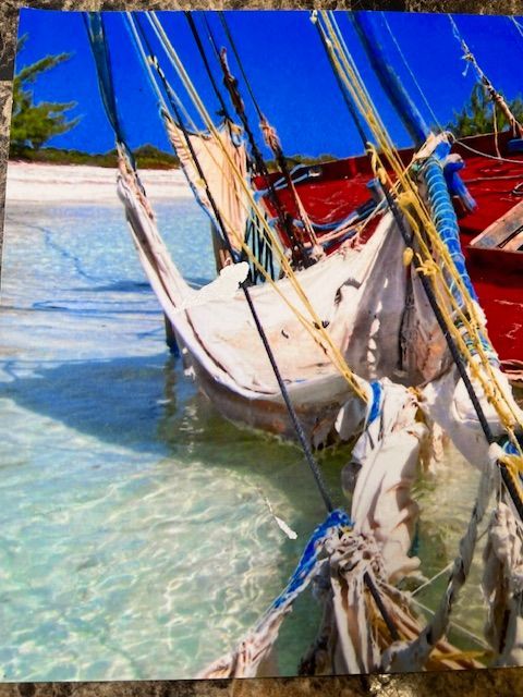 A painting of boats in the water on a beach