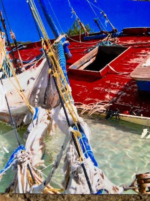 A painting of boats in the water with a blue sky in the background